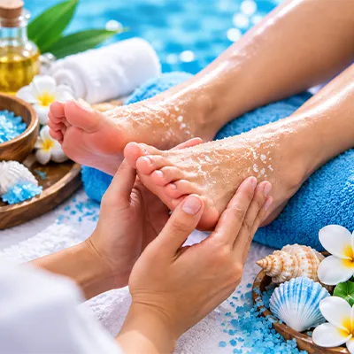 Person receiving a relaxing foot massage at a spa.